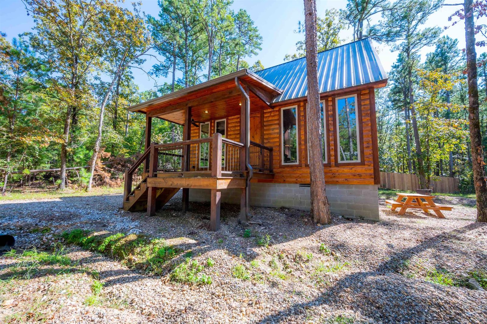 Blue Night Sky cabin with covered porch and picnic table in the pines