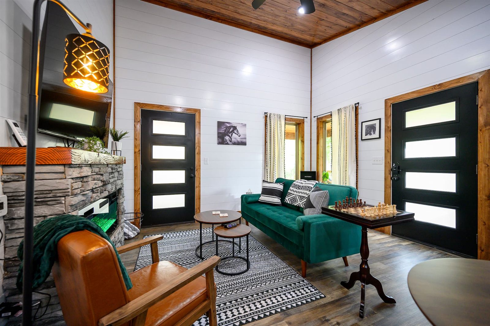 Emerald Star living room with emerald velvet sofa and stone fireplace